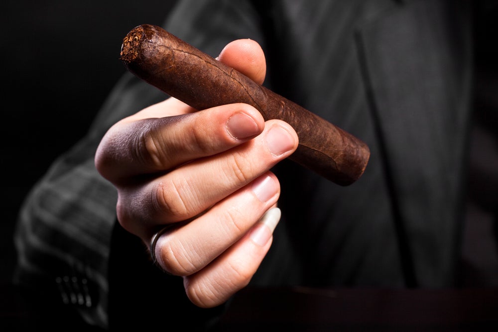 shutterstock_47700049-man-holding-cigar