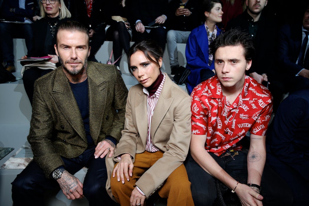 David, Victoria and Brooklyn Beckham at the Louis Vuitton Fall/Winter 2018 runway at Paris Fashion Week (Photo: Courtesy of LOUIS VUITTON) / SWAGGER Magazine