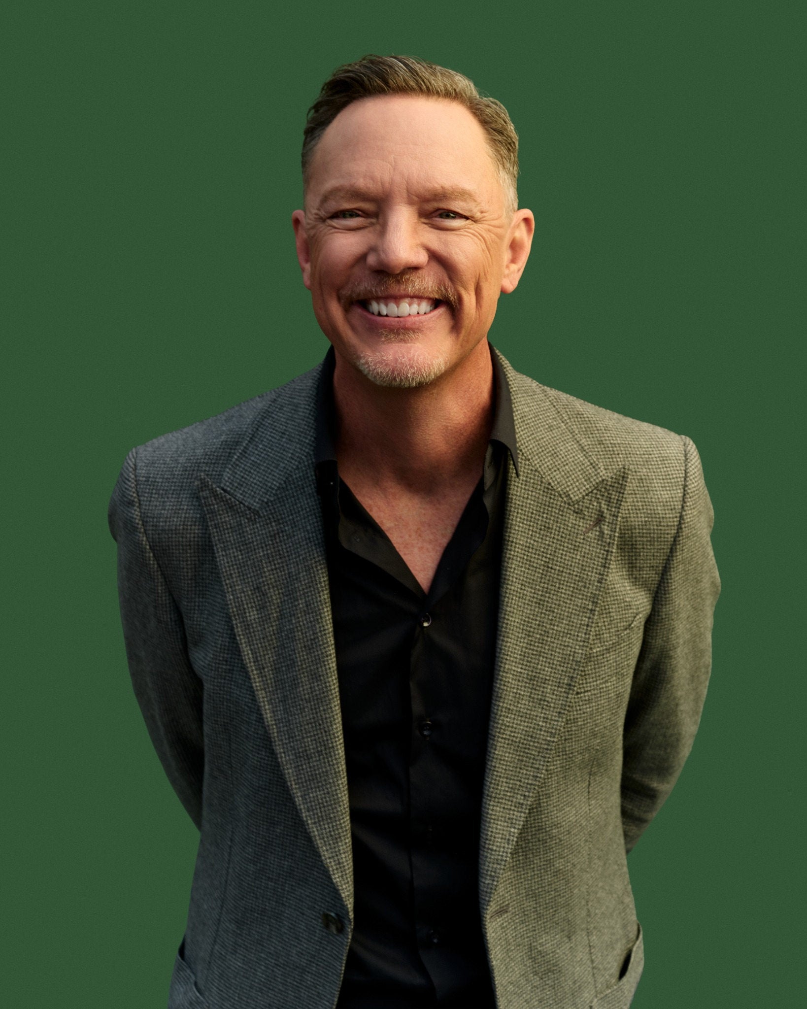 Matthew Lillard photographed against a green studio backdrop