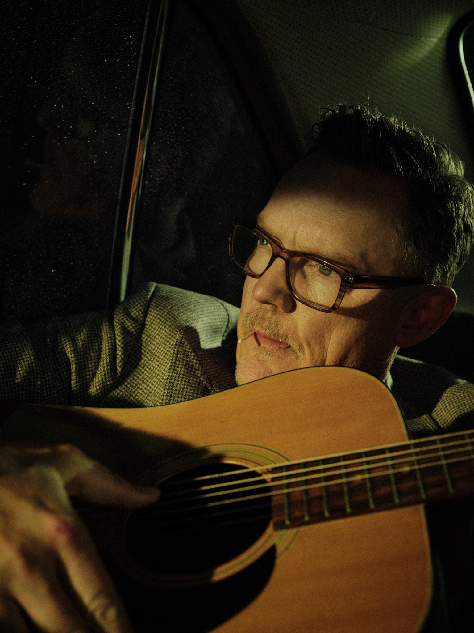 Matthew Lillard with an acoustic guitar
