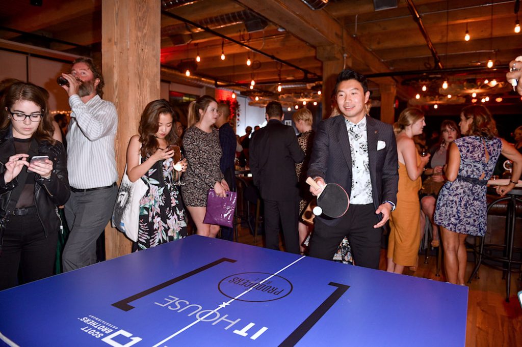 Simu Liu at the IT House Producers Ball TIFF 2018 Ping Pong Table | SWAGGER Magazine
