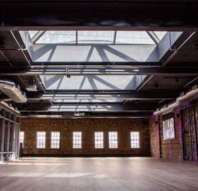 events space with skylight, brick walls and wood floors